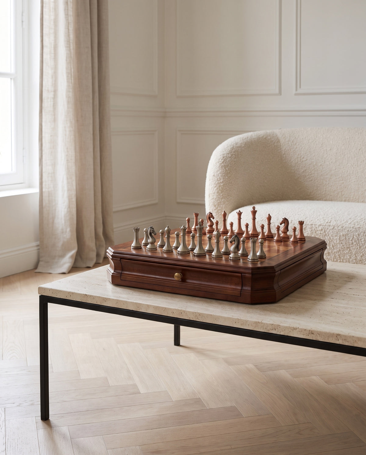 The Sovereign mahogany chess set with metal pieces on a travertine table