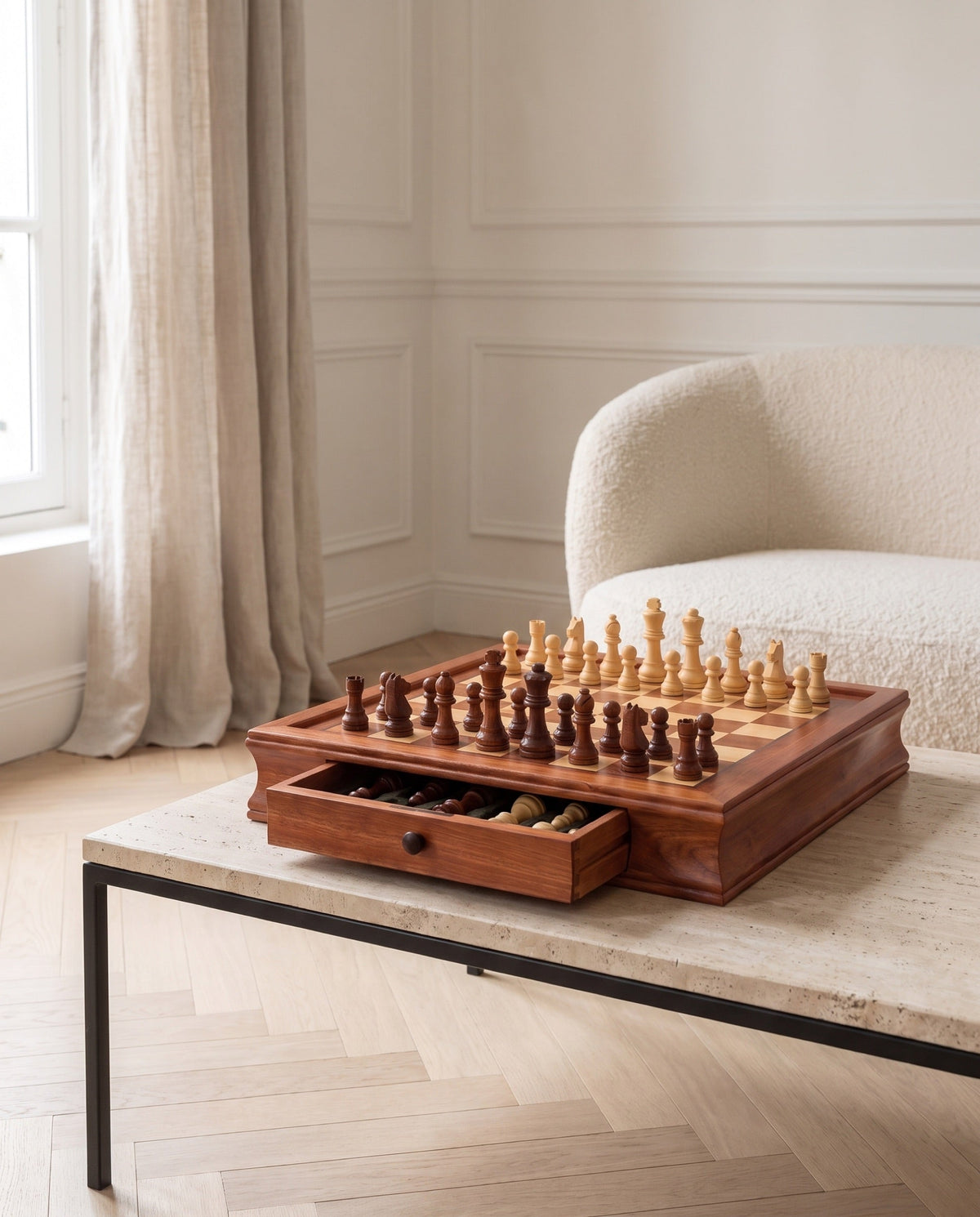 The Vault maple chess set with drawer open on a travertine table