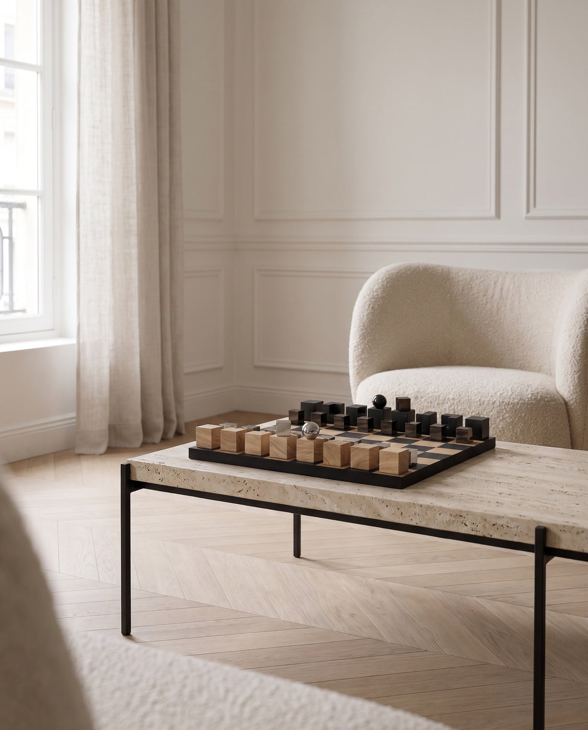 The Oslo oak chess set on a travertine table in a Nordic-Haussmannian salon