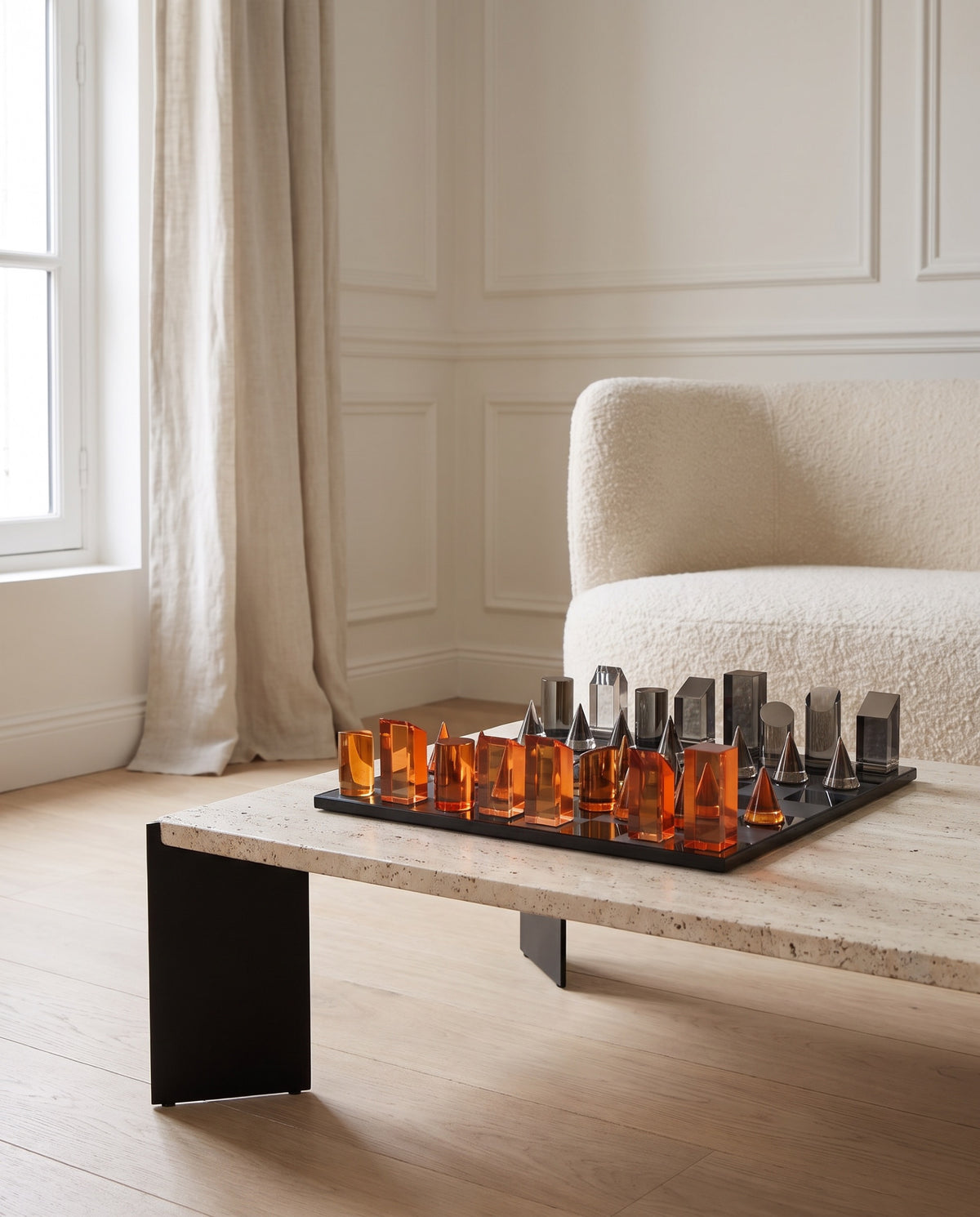 The Prism crystal chess set on a travertine table