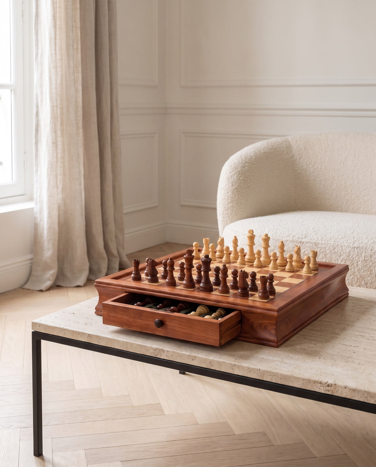 The Vault maple chess set with drawer open on a travertine table